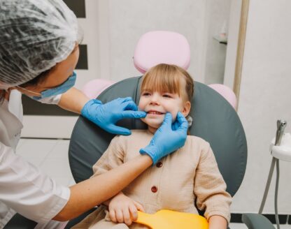 Young girl smiling during a dental exam at Richard L. Lachenmayr, D.M.D. in Alpha, NJ, highlighting the importance of regular check-ups for children. 